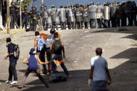 Demonstrators clash with riot police during a rally to demand a referendum to remove Venezuela's President Nicolas Maduro in San Cristobal, Venezuela. REUTERS/Carlos Eduardo Ramirez