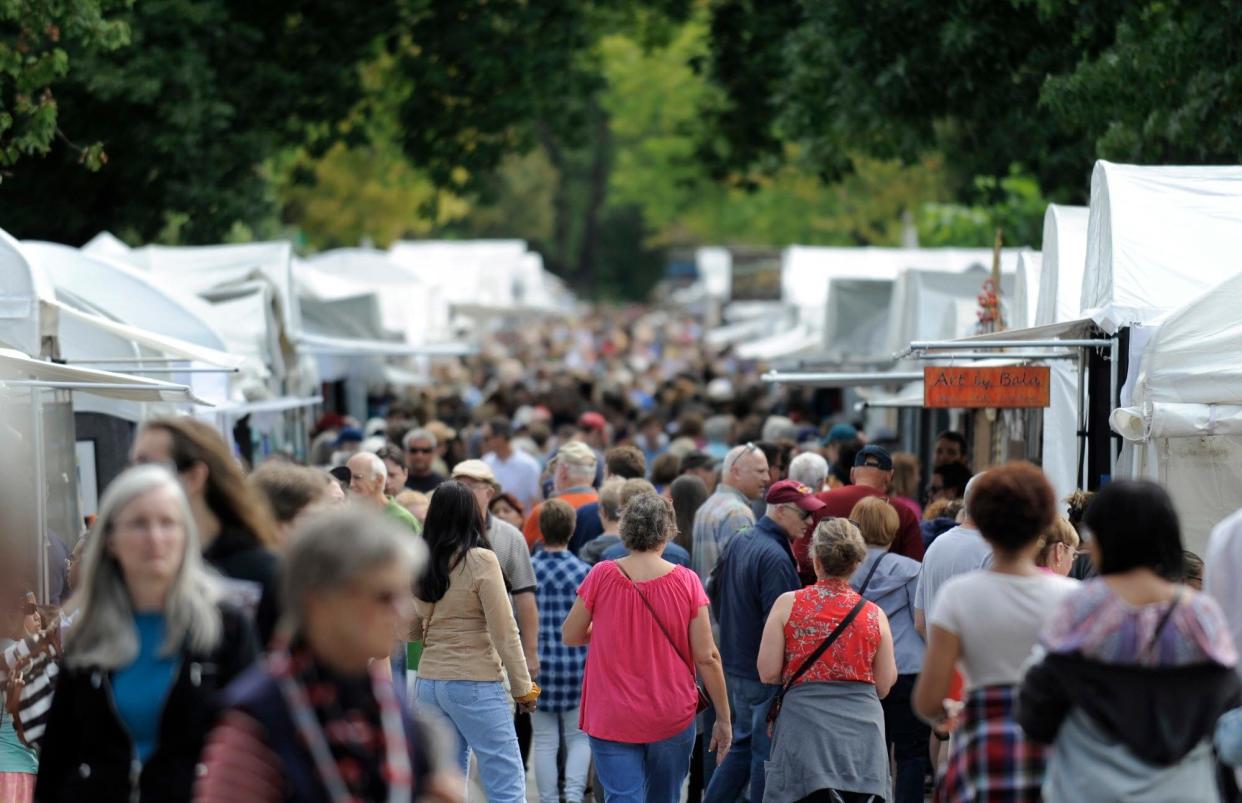 Throngs of visitors fill East Fourth Street Saturday during the Fourth Street Festival of the Arts & Crafts. First held in 1977, the two-day downtown festival is an annual Labor Day event.