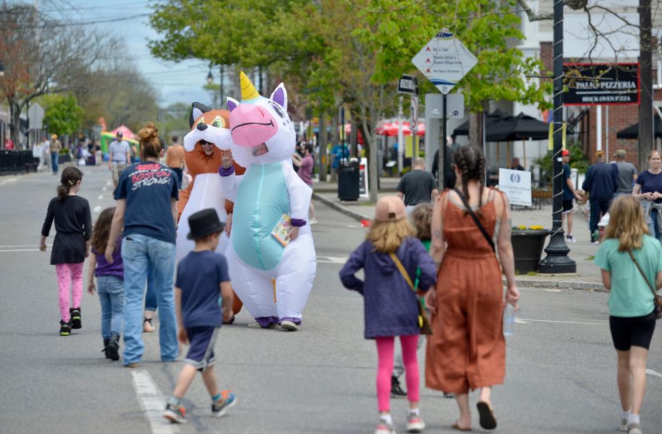 Zoe Bundschuh, of Hyannis, left, and sister Eliza Bundschuh walk along Main Street dressed as a fox and unicorn as part of the cast of characters making the rounds during Hyannis Open Streets. Hyannis Open Streets was held along Main Street Sunday afternoon. Main Street was closed between Barnstable and Sea Streets for family friendly activities. To see more photos, go to www.capecodtimes.com/news/photo-galleries. Merrily Cassidy/Cape Cod Times