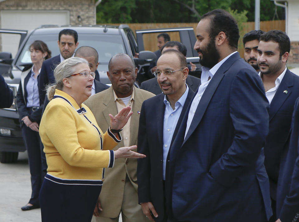 ADDS NAME OF SUSPECT - In this April 7, 2018, file photo, Saudi Crown Prince Mohammed bin Salman, front right, talks with Habitat for Humanity Executive Director Allison Hay, front left, surrounded by his entourage as he tours a flood-damaged area in Houston, Texas. A man, rear second from left, in this image identified by Turkish officials as Maher Abdulaziz Mutreb, also appears in pro-government Turkish newspaper images also showing him on surveillance video walking into the Saudi Consulate in Istanbul before writer Jamal Khashoggi vanished. Saudi Arabia, which initially called the allegations "baseless," has not responded to repeated requests for comment from The Associated Press over recent days, including on Thursday over Mutreb’s identification. (Strever Gonzales/Houston Chronicle via AP)