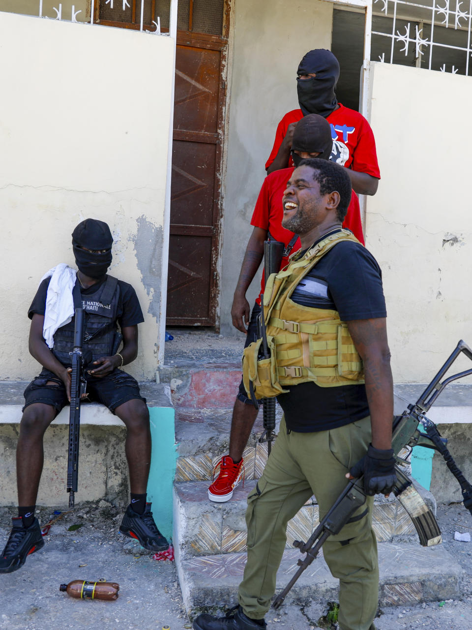 Barbecue, the leader of the "G9 and Family" gang, stands with his gang after speaking to journalists in the Delmas 6 neighborhood of Port-au-Prince in Port-au-Prince, Haiti, Tuesday, March 5, 2024. Haiti's latest violence began with a direct challenge from Barbecue, a former elite police officer, who said he would target government ministers to prevent the prime minister's return and force his resignation. (AP Photo/Odelyn Joseph)