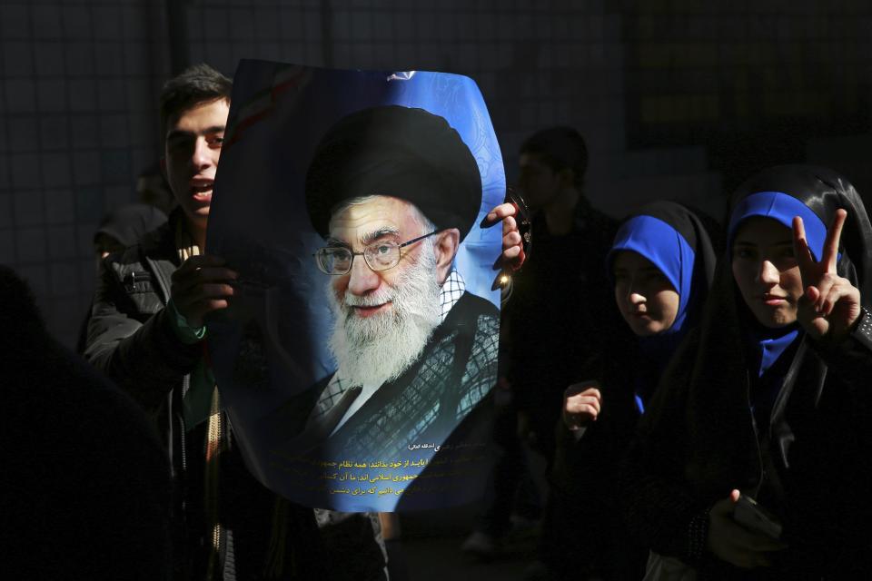 A man holds a poster of the Iranian Supreme Leader Ayatollah Ali Khamenei during an annual rally commemorating the anniversary of the 1979 Islamic revolution, on Azadi (Freedom) Street in Tehran, Iran, Tuesday, Feb. 11, 2014. Tuesday marked the 35th anniversary of the revolution that toppled the pro-U.S. Shah Mohammad Reza Pahlavi and brought Islamists to power. (AP Photo/Ebrahim Noroozi)