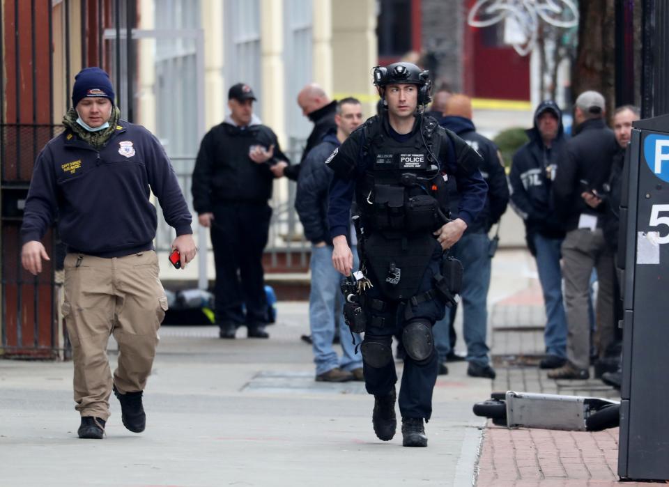 Yonkers police work outside 52 Main St. in Yonkers Jan. 17, 2022 after police shot a man wielding a gun inside an apartment. The suspect was shot in the leg, and one officer suffered a concussion. Both were taken to a local hospital with non-life threatening injuries.