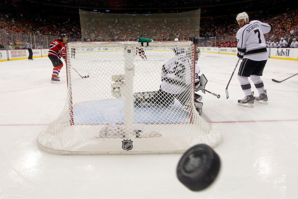 NEWARK, NJ - JUNE 09: Jonathan Quick #32 and Rob Scuderi #7 of the Los Angeles Kings look back as the puck hits the glass against the New Jersey Devils during Game Five of the 2012 NHL Stanley Cup Final at the Prudential Center on June 9, 2012 in Newark, New Jersey. (Photo by Paul Bereswill/Getty Images)