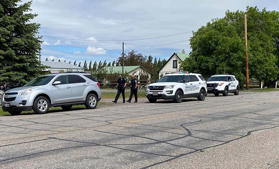 In this photo provided by East Idaho News shows authorities outside a home after serving a warrant in Salem, Idaho, on Tuesday June 9, 2020.