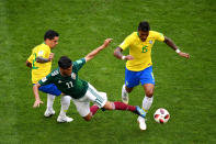 <p>Carlos Vela of Mexico tackles Paulinho of Brazil during the 2018 FIFA World Cup Russia Round of 16 match between Brazil and Mexico at Samara Arena on July 2, 2018 in Samara, Russia. (Photo by Hector Vivas/Getty Images) </p>