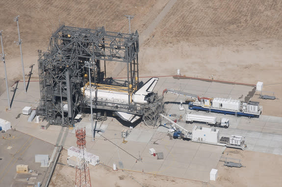 Space Shuttle Discovery is surrounded by the Mate-DeMate Device gantry and ground support equipment at NASA’s Dryden (now Armstrong) Flight Research Center during processing for its ferry flight back to the Kennedy Space Center in Florida after