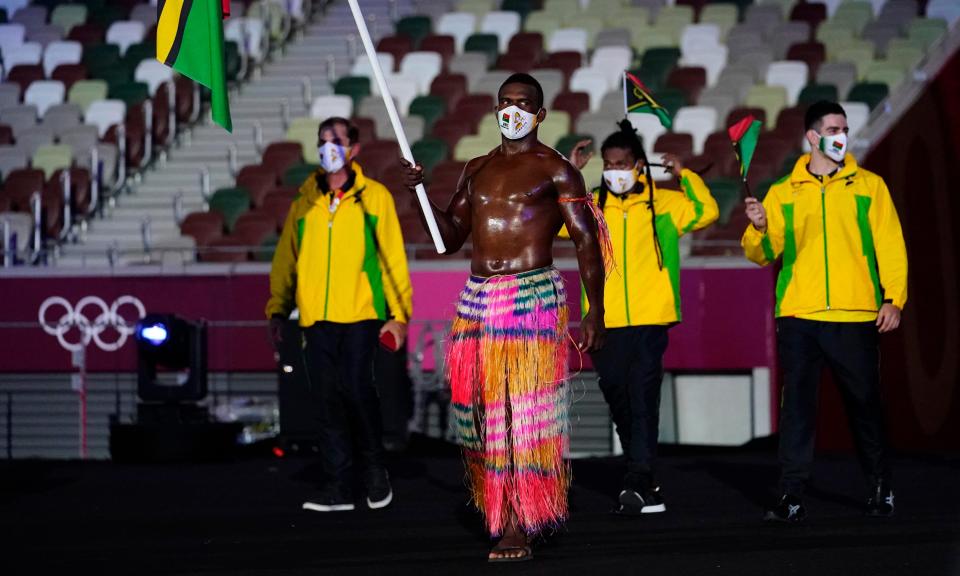 Vanuatu flag bearer Riilio Rii leads his delegation during the opening ceremony.
