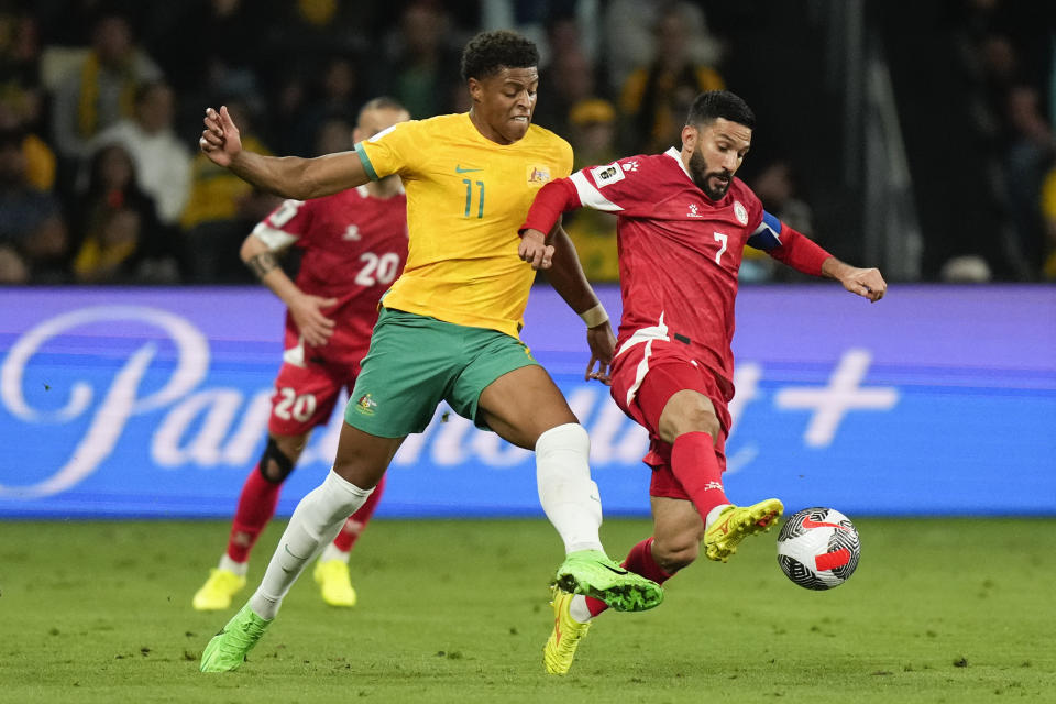 Australia's Kusini Yengi, left. and Lebanon's Hassan Maatouk battle during the Soccer World Cup qualifying match between Lebanon and Australia in Sydney, Australia, Thursday, March 21, 2024. (AP Photo/Rick Rycroft)