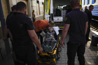 A woman fleeing from shelling waits in a stretcher to board an evacuation train at the train station, in Pokrovsk, eastern Ukraine, eastern Ukraine, Friday, May 27, 2022. Volunteers have been racing to evacuate as many civilians as possible, particularly the elderly and those with mobility issues, as Russian forces make advances in the region. (AP Photo/Francisco Seco)