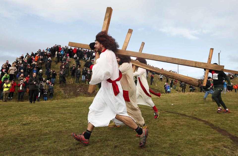 Competitors dressed as Jesus carry crosses as the start the Tough Guy event in Perton, central England