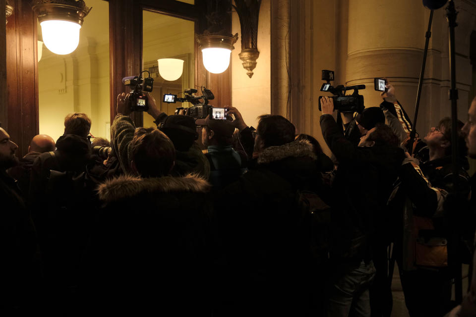 FILE - Members of the media wait outside the Justice Palace during a pre-trial court hearing in Brussels, Wednesday, Dec. 14, 2022. Judicial officials have told The Associated Press that Eva Kaili, a Greek European lawmaker charged with corruption in an alleged plot tarnishing EU institutions, will remain in detention until at least Dec. 22 after her hearing by a judge was postponed. (AP Photo/Gert Jochems, File)