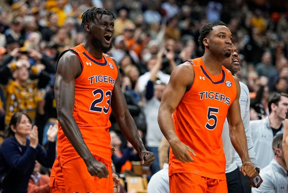 Jan 25, 2022; Columbia, Missouri, USA; Auburn Tigers center Babatunde Akingbola (23) and Auburn Tigers forward Chris Moore (5) celebrate after a basket late in the second half against the Missouri Tigers at Mizzou Arena. Mandatory Credit: Jay Biggerstaff-USA TODAY Sports