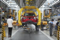 Workers assemble a car at a Vinfast factory in Hai Phong, Vietnam, on Sept. 29, 2023. Vietnamese automaker Vinfast has plunged right into the crowded and hypercompetitive U.S. auto market, gambling that if it can sell its electric vehicles to finicky Americans, it can succeed anywhere. So far, that gamble has yet to pay off. (AP Photo/Hau Dinh)