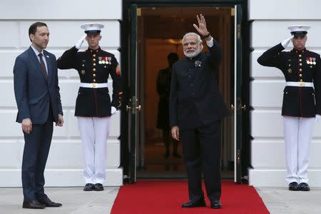 U.S. Chief of Protocol Ambassador Peter Selfridge (L) greets Indian Prime Minister Narendra Modi as he arrives for a working dinner with heads of delegations for the Nuclear Security Summit at the White House in Washington March 31, 2016. REUTERS/Jonathan Ernst