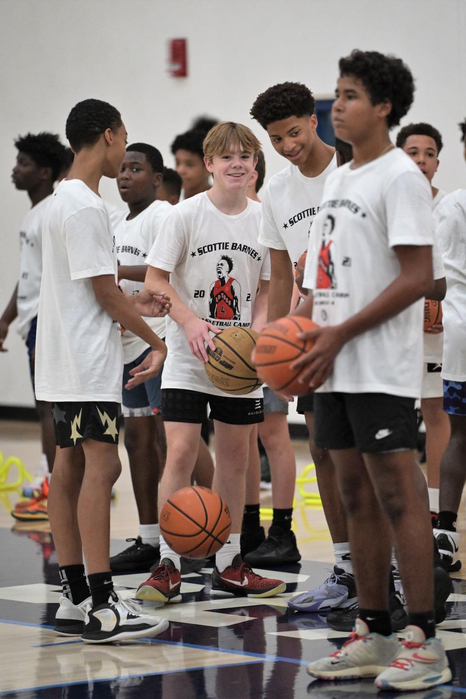 Grandview Prep's Kyle Zaner looks on alongside fellow youth basketball players as drills get underway during the Scottie Barnes basketball camp last week.