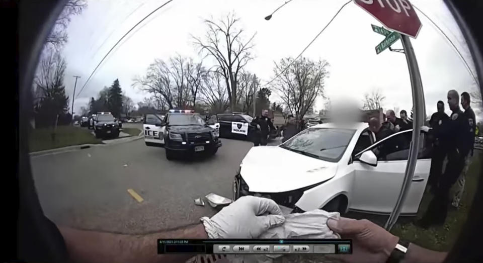 CORRECTS TO BODY CAM OF BROOKLYN CENTER POLICE OFFICER JEFFREY SOMMERS, NOT CHAMPLIN POLICE OFFICER DANIEL IRISH - In this image taken from Brooklyn Center Police Officer Jeffrey Sommers' police body cam video that was played during the trial of former Brooklyn Center police Officer Kim Potter on Thursday, Dec. 9, 2021, in Minneapolis, police approach the car that Daunte Wright was driving after being shot during a traffic stop. Potter, who is white, is charged with first- and second-degree manslaughter in the shooting of Wright, a Black motorist, in the suburb of Brooklyn Center. Potter has said she meant to use her Taser – but grabbed her handgun instead – after Wright tried to drive away as officers were trying to arrest him. (Court TV, via AP, Pool)