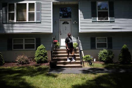 Michael Payne stands in front of his home in the Penn Estates development where most of the homeowners are underwater on their mortgages in East Stroudsburg, Pennsylvania, U.S., June 20, 2018. REUTERS/Mike Segar