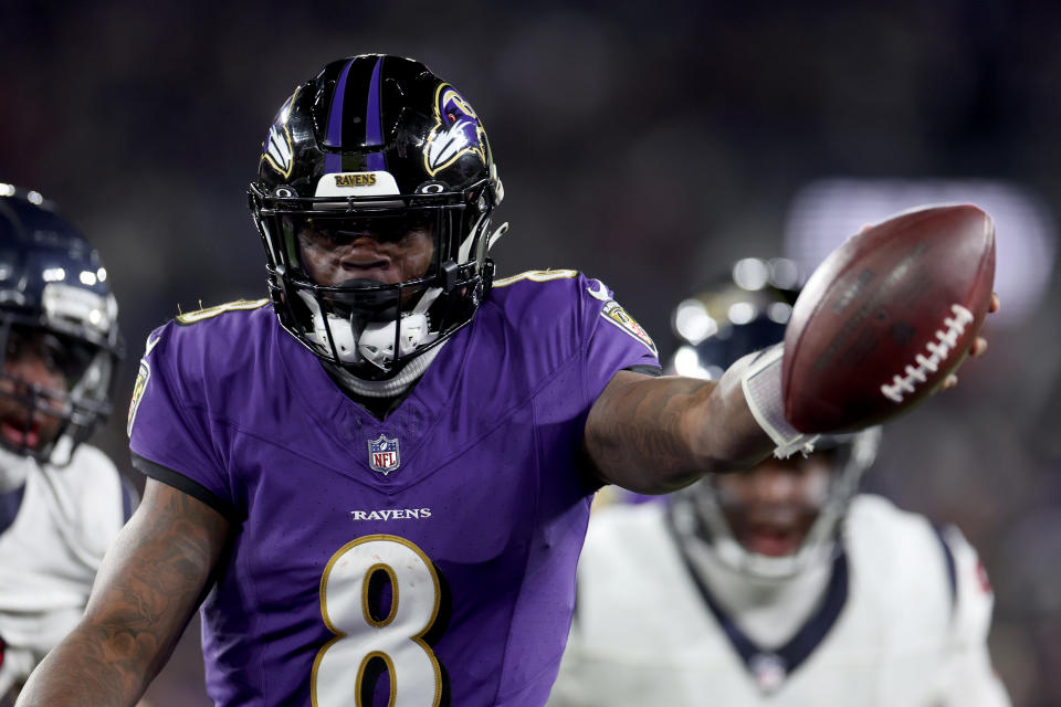 BALTIMORE, MARYLAND - JANUARY 20: Lamar Jackson #8 of the Baltimore Ravens scores an 8 yard touchdown against the Houston Texans during the fourth quarter in the AFC Divisional Playoff game at M&T Bank Stadium on January 20, 2024 in Baltimore, Maryland. (Photo by Rob Carr/Getty Images)