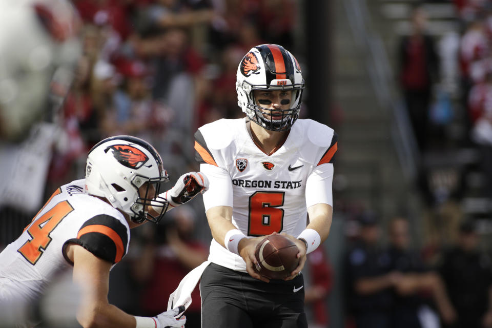 Oregon State quarterback Jake Luton (6) hands the ball off to running back Ryan Nall during the first half of an NCAA college football game in Pullman, Wash., Saturday, Sept. 16, 2017. (AP Photo/Young Kwak)