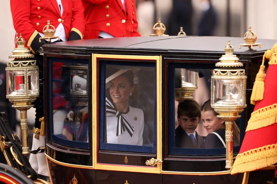 Kate, Prince George, Princess Charlotte and Prince Louis watching the crowds that lined The Mall (Reuters)