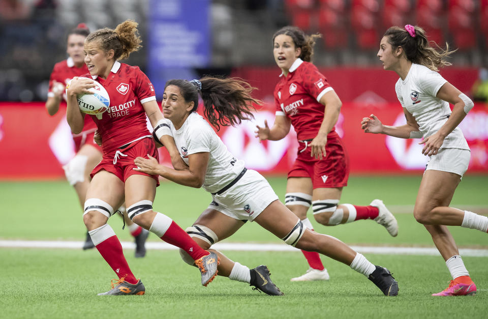 Canada's Renee Gonzalez, left, is tackled by United States' Sarah Levy during an HSBC Canada Sevens women's semifinal rugby match in Vancouver, British Columbia, Sunday, Sept. 19, 2021. (Darryl Dyck/The Canadian Press via AP)