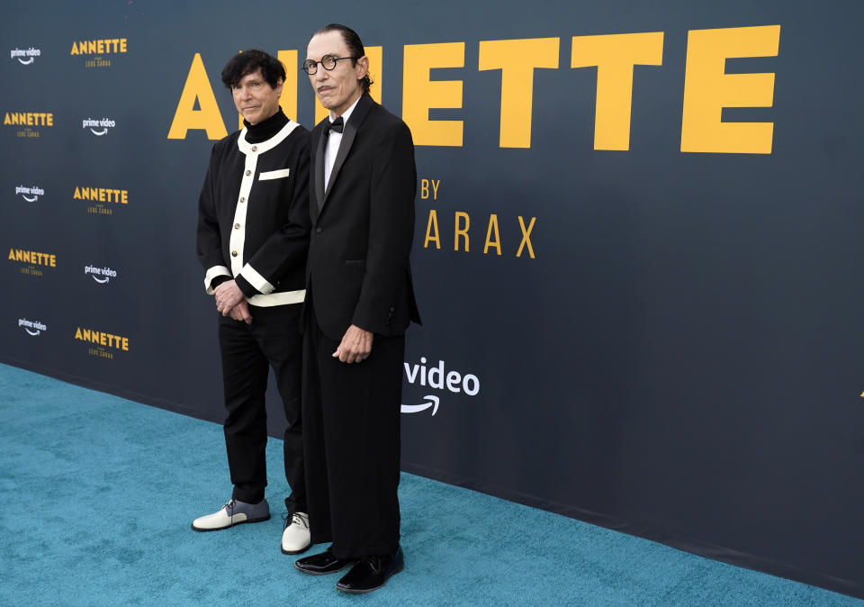 Russell Mael, left, and his brother Ron of the band Sparks pose together at a special screening of the film “Annette” at the Hollywood Forever Cemetery, Aug. 18, 2021 - Credit: Chris Pizzello/Invision/AP