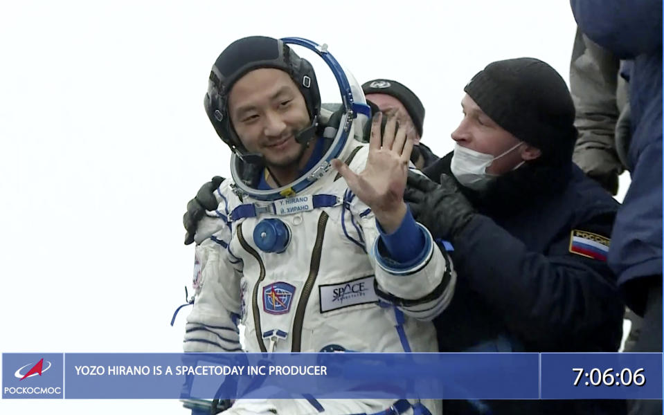 In this photo taken from video footage released by the Roscosmos Space Agency, Russian space agency rescue team help spaceflight participant Yozo Hirano to get from the capsule shortly after the landing of the Russian Soyuz MS-20 space capsule about 150 km ( 80 miles) south-east of the Kazakh town of Zhezkazgan, Kazakhstan, Monday, Dec. 20, 2021. A Japanese billionaire, his producer and a Russian cosmonaut safely returned to Earth on Monday after spending 12 days on the International Space Station. (Roscosmos Space Agency via AP)