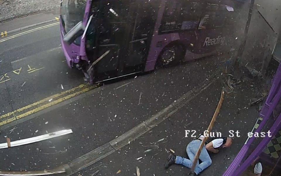 The pedestrian lies on the pavement after being thrown around 20ft - as the bus goes in a different direction - Credit: Purple Turtle/SWNS