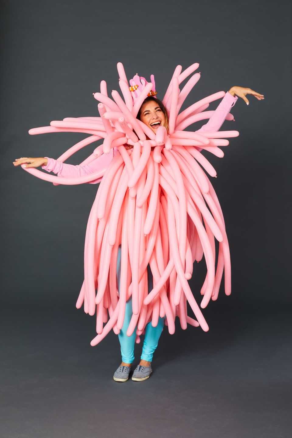 <p>Here's one way to make an entrance. Blow up long, pink balloons and attach them by the knot to a pink shirt with safety pins. Sprinkle in a few context clues, so people can figure out what you're dressing up as, like a felt crown embellished with plastic fish. </p>