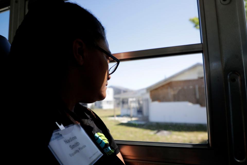 Nadine Smith, executive director of Equality Florida, looks out a bus window on April 16, 2019, at one of the homes on Tyndall Air Force Base that was destroyed by Hurricane Michael. Smith joined Florida Chamber Foundation members and other statewide leaders on the two-day Hurricane Michael Recovery Mission.