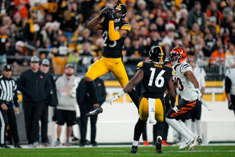 Pittsburgh Steelers safety Eric Rowe (25) intercepts a pass intended for Cincinnati Bengals wide receiver Tyler Boyd (83) in the second quarter of the NFL 16 game between the Pittsburgh Steelers and the Cincinnati Bengals at Acrisure Stadium in Pittsburgh on Saturday, Dec. 23, 2023. The Steelers led 24-0 at halftime.