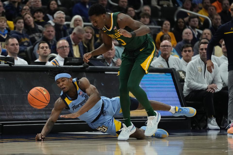 Marquette's Chase Ross and Baylor's Dale Bonner go after a loose ball during the first half of an NCAA basketball game Tuesday, Nov. 29, 2022, in Milwaukee. (AP Photo/Morry Gash)