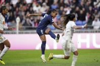 PSG's Marie-Antoinette Katoto, center, scores her side's second goal during the women's Champions League semifinals, first leg, soccer match between Olympique Lyonnais and Paris Saint-Germain at Parc Olympique Lyonnais, in Lyon, France, Saturday, April 20, 2024. (AP Photo/Laurent Cipriani)