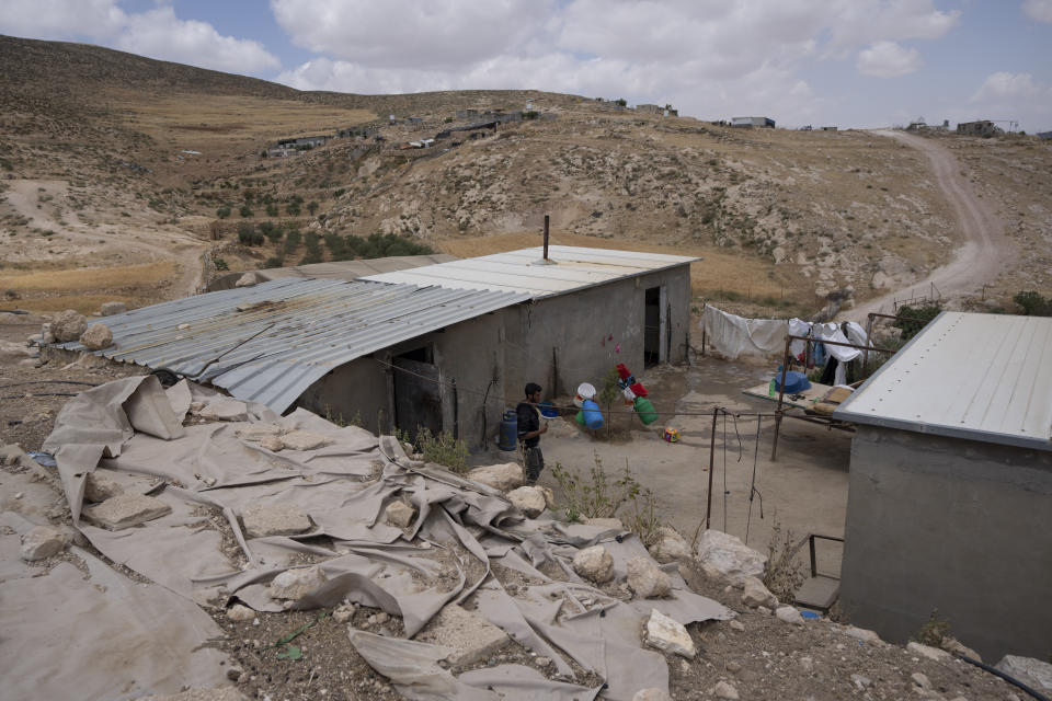 FILE - A Palestinian man walks inside his house in the West Bank Beduin community of Jinba, Masafer Yatta, Friday, May 6, 2022. The Israeli military has demolished homes, water tanks and olive orchards in two Palestinian villages in the southern West Bank where some residents are at risk of imminent expulsion, residents and activists said Wednesday, Jan. 4, 2023.(AP Photo/Nasser Nasser, File)