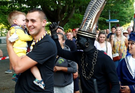 "The Savage", a white performer in a blackface disguise, takes part in the festival Ducasse d'Ath in Ath