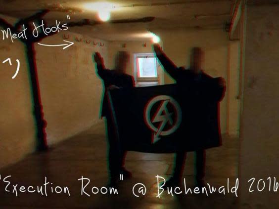 Mark Jones and another man giving a Nazi salute at Buchenwald death camp in Germany