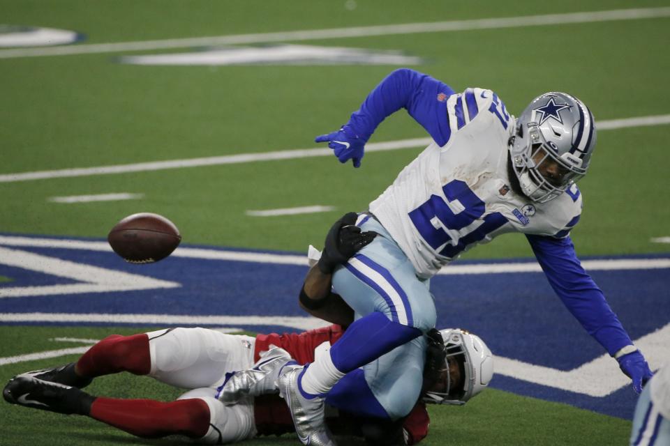 Arizona Cardinals safety Budda Baker (32) strips the ball from Dallas Cowboys running back Ezekiel Elliott (21) in the first half of an NFL football game in Arlington, Texas, Monday, Oct. 19, 2020. (AP Photo/Michael Ainsworth)