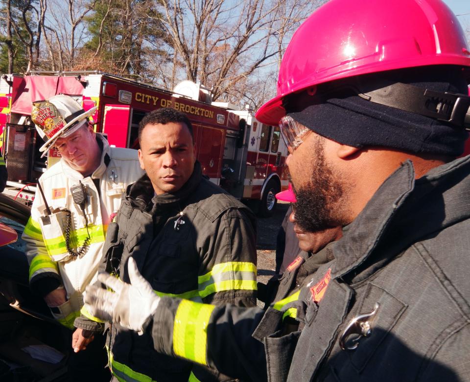 Brockton Deputy Fire Chief Scott Albanese looks on as Brockton Firefighter Helio Lima talks with Praia Cape Verde Deputy Ronaldo Varela during joint fire training exercises on Thursday, Nov. 30, 2023.