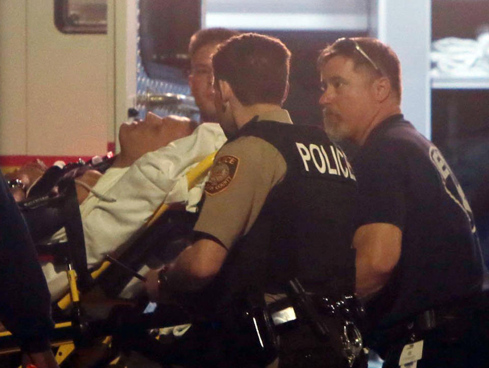 Paramedics carry one of two police officers who were shot while standing guard in front of the Ferguson police station during a protest in March. (Laurie Skrivan/St. Louis Post-Dispatch, AP)