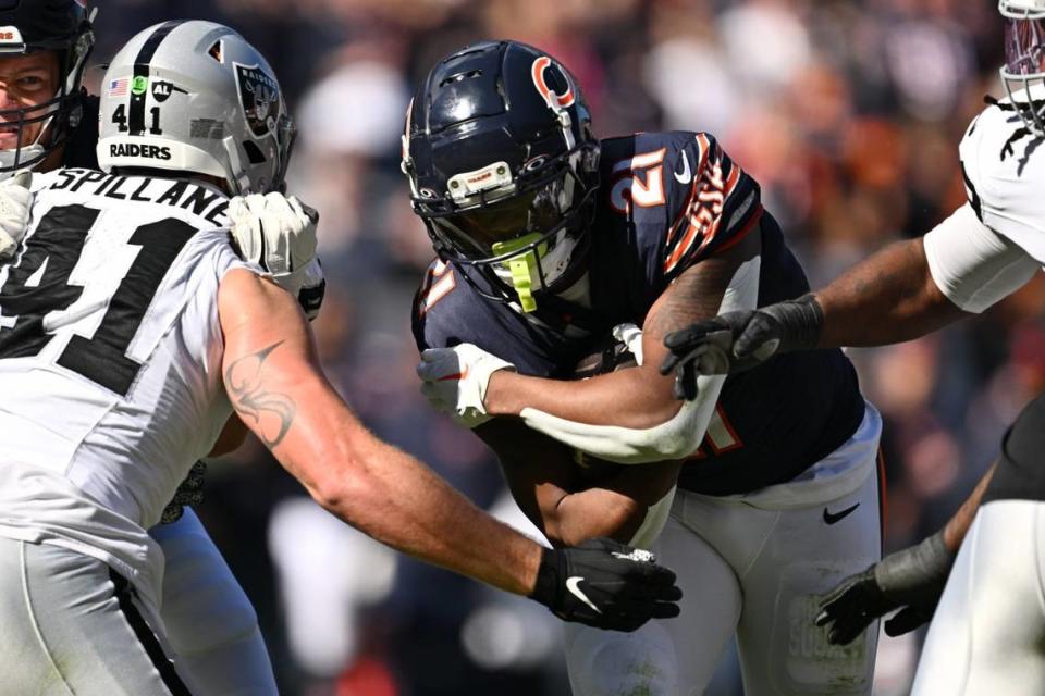 Chicago Bears running back D’Onta Foreman (21) fights through a tackle attempt from Las Vegas Raiders linebacker Robert Spillane (41). Mandatory Credit: Jamie Sabau-USA TODAY Sports