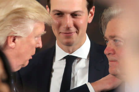 FILE PHOTO: U.S. President Donald Trump talks to senior staff Steve Bannon (R) and Jared Kushner (C) during a swearing in ceremony for senior staff at the White House in Washington, DC January 22, 2017. REUTERS/Carlos Barria/File Photo