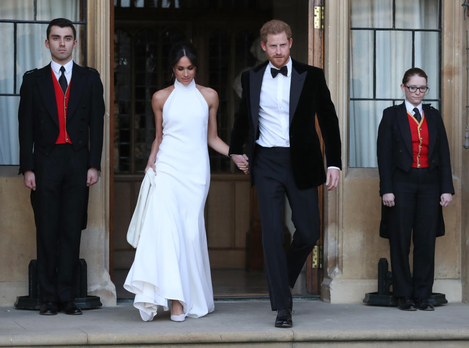 <p>Meghan and Harry make their way to their evening reception on their wedding day. The bride wore a second dress by Stella McCartney (Getty) </p>