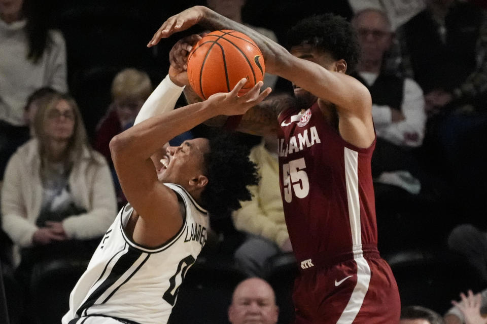 Vanderbilt guard Tyrin Lawrence (0) is fouled by Alabama guard Aaron Estrada (55) during the second half of an NCAA college basketball game Saturday, Jan. 6, 2024 in Nashville, Tenn. Alabama won 78-75. (AP Photo/George Walker IV)