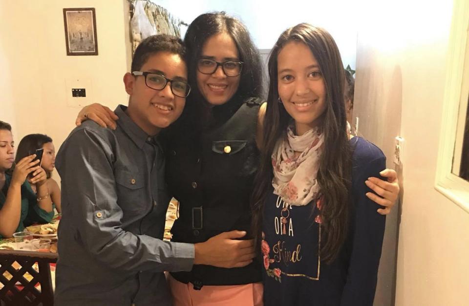 Ydelisa Cervantes (center) remains separated from her adopted children, who are still in Venezuela.