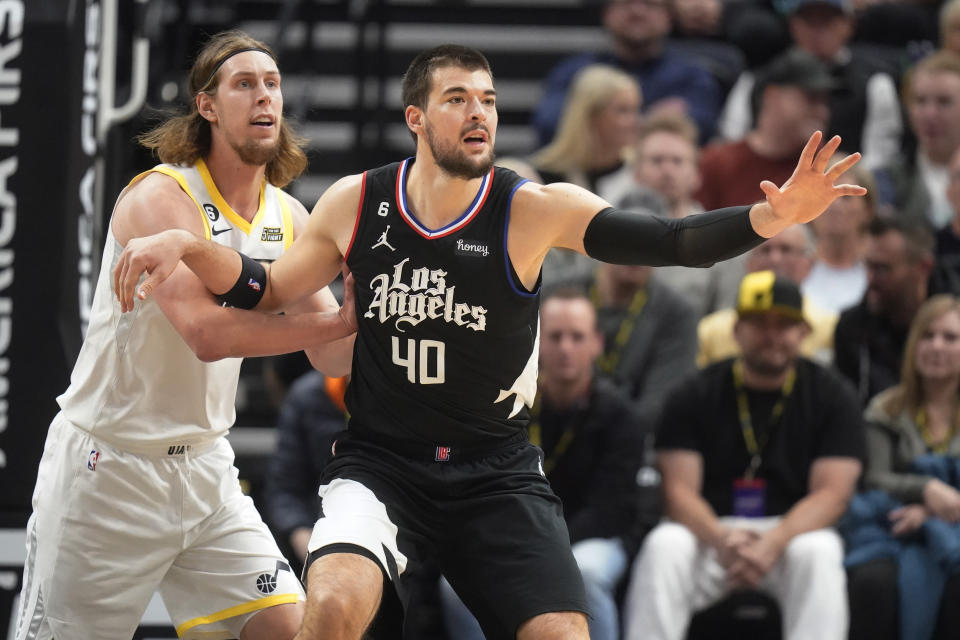 Utah Jazz forward Kelly Olynyk, left, guards Los Angeles Clippers center Ivica Zubac (40) during the first half of an NBA basketball game Wednesday, Nov. 30, 2022, in Salt Lake City. (AP Photo/Rick Bowmer)