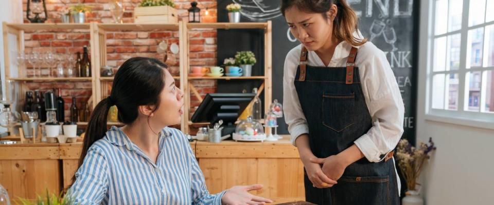 Waitress looking confused at annoyed customer