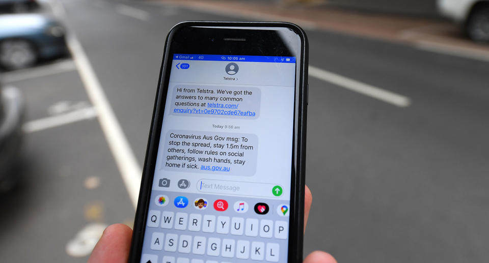 Generic image of a health warning from Telstra on a mobile phone in Melbourne, Wednesday, March, 25, 2020. Telstra has begun issuing health warnings via their telecommunications service. (AAP Image/James Ross) NO ARCHIVING