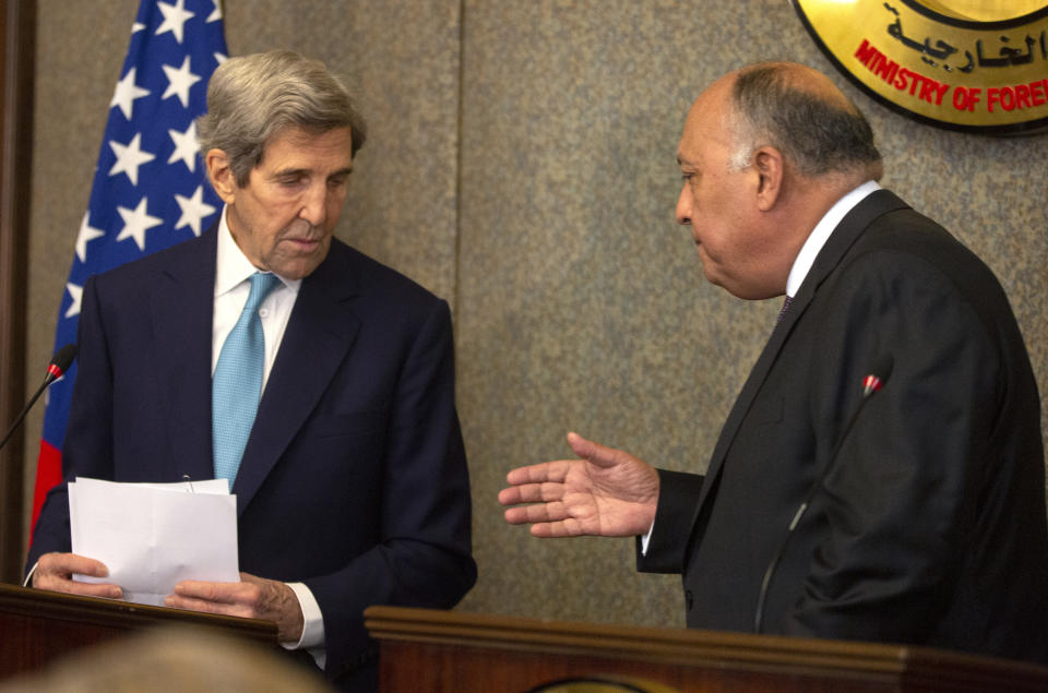 Egyptian Foreign Minister Sameh Shoukry, right, greets U.S. Special Presidential Envoy for Climate John Kerry after a press conference at the foreign ministry headquarters in Cairo, Egypt, Monday, Feb. 21, 2022. (AP Photo/Amr Nabil)