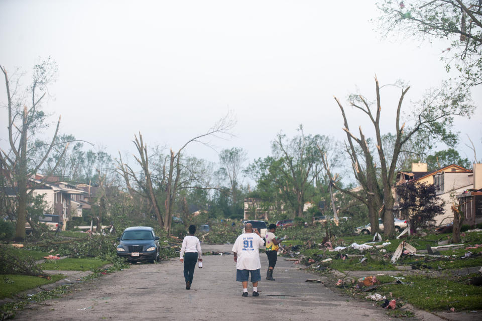 Residents of the West Brook neighborhood emerge from shelter to inspect the damage in their neighborhood after a suspected ef-4 tornado touched down early in the morning on May 28, 2019 in Trotwood, Ohio. (Photo: Matthew Hatcher/Getty Images)